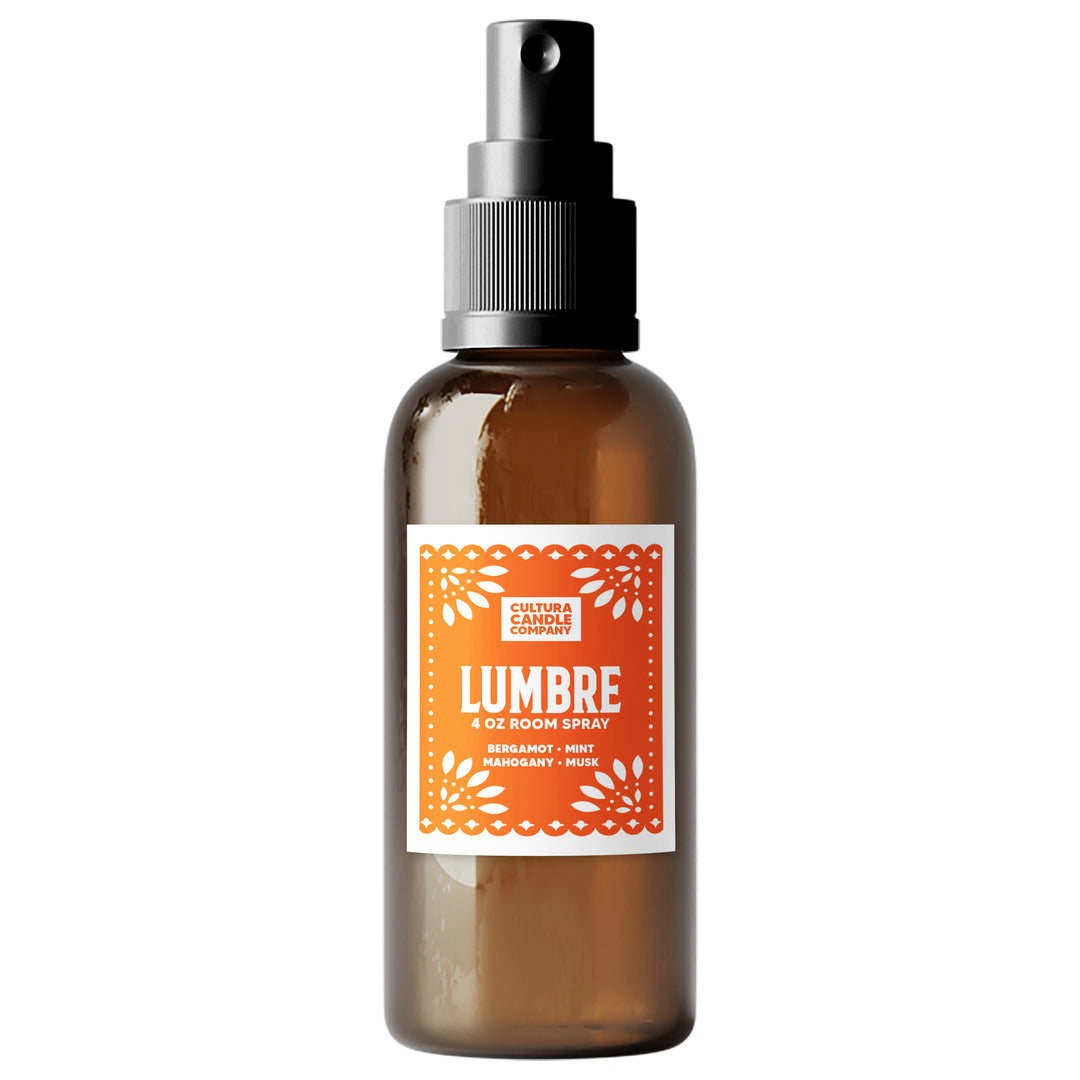 An amber glass room spray bottle with a black spray nozzle and a white label featuring orange text and border details. The label reads 'LUMBRE' and 'CULTURA CANDLE COMPANY'.