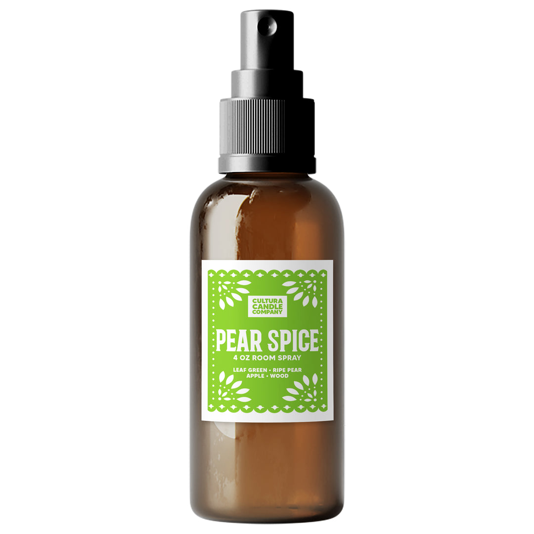 An amber glass room spray bottle with a black spray nozzle and a green and white label reading 'PEAR SPICE' by Cultura Candle Company, shown on a plain white background.
